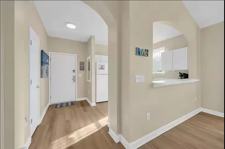 Our front entryway with a pass through window from the kitchen to the dining and living areas. Keep the entire family engaged while preparing meals!