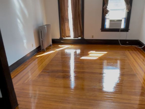 Living room hard yellow pine floors throughout the apartment