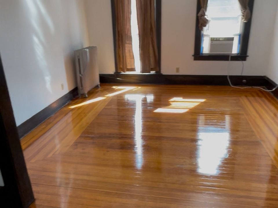 Living room hard yellow pine floors throughout the apartment