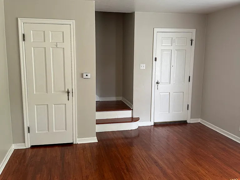 Living room with closet and outside entrance