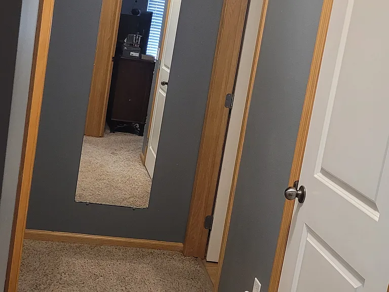 Upstairs hallway from bedroom doors. Bathroom is on the right at the end of the hall.