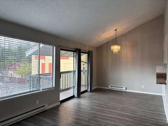 Large living space with dining space and bar to kitchen. - 4526 S Henderson St #301