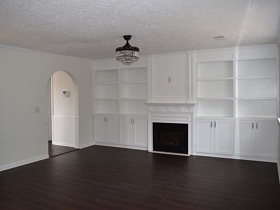 Spaces Family room with fireplace and lots of storage.