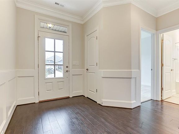 Front door entrance and hallway to bedroom and bath