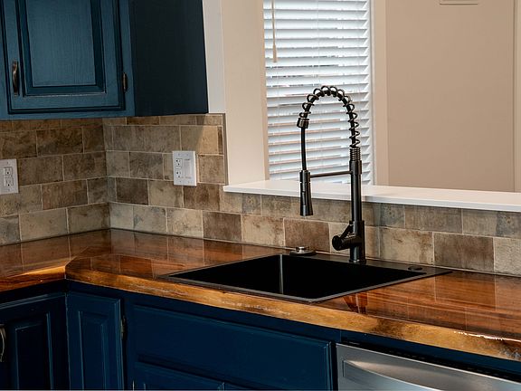 Kitchen with air fryer range, dishwasher, microwave, garbage disposal, refrigerator, dimmable lighting