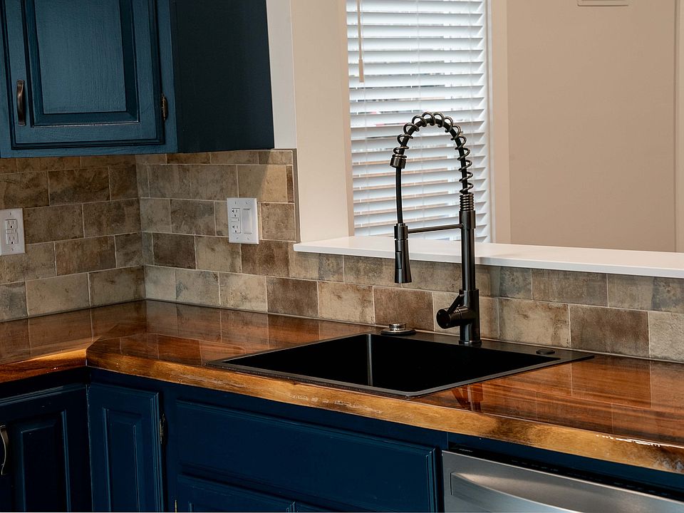 Kitchen with air fryer range, dishwasher, microwave, garbage disposal, refrigerator, dimmable lighting