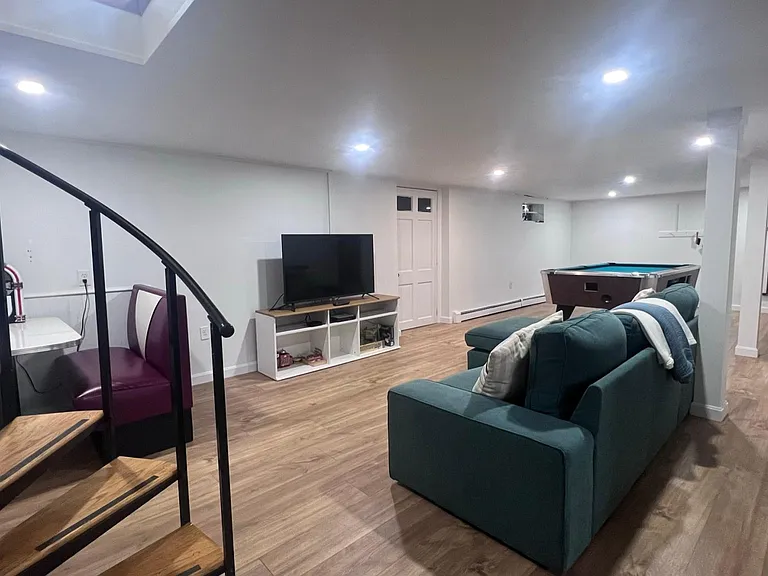 Spiral stairs down to basement entertainment space