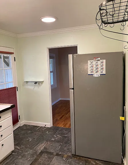 Kitchen view from hallway entrance looking at dining nook and door to sunroom.