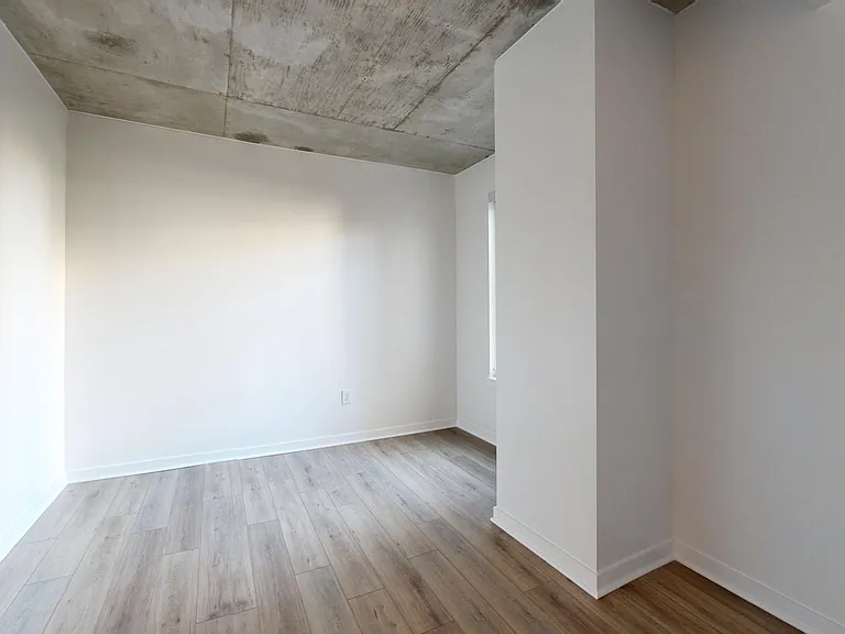 Apartment study with wood-style flooring.