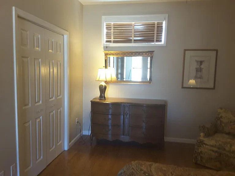 Large closet and seating area in bedroom.