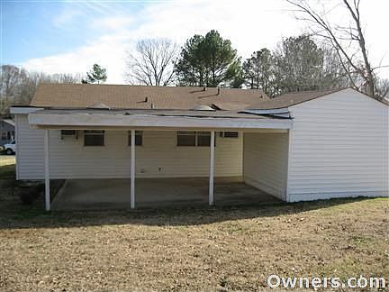 back of house looking at the utility rm & covered cement patio