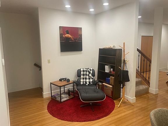 Living room with entry to right and lower lever stairs to left.