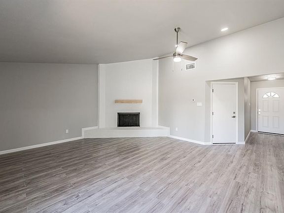 View towards living room and door to the garage. Upgrades laminate flooring throughout.