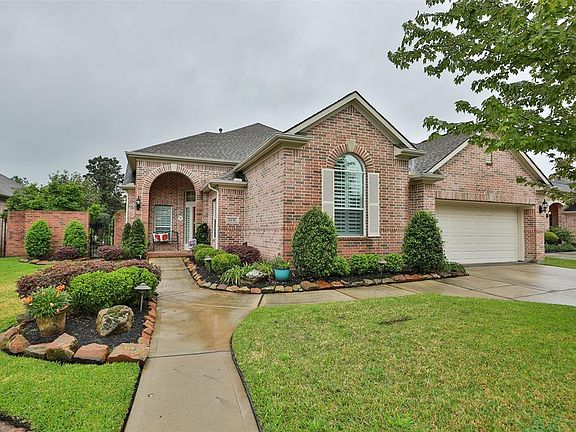 Mature plantings and stone lined garden beds offer a lovely view as you sit on your covered front porch!
