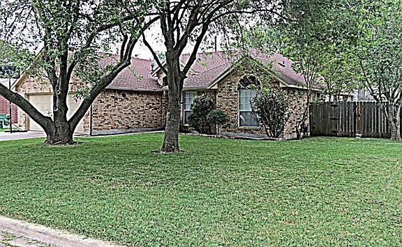Large yard with extensive shade trees.