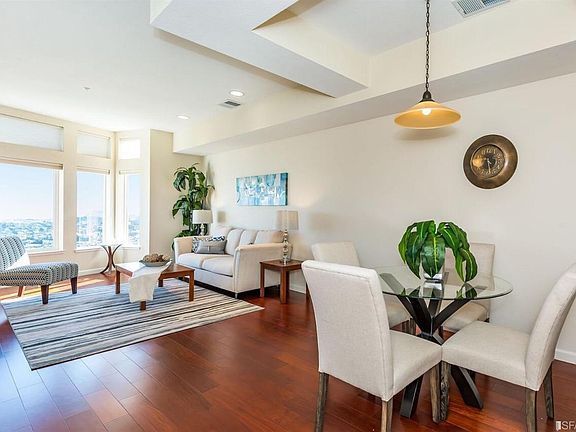Living and dining area. Note: the dining area has a new/modern hoop shaped chandelier (photo is out of date).