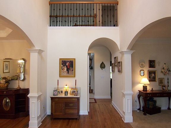 Inviting Foyer with hardwood floors,barrel ceiling entry to Family room