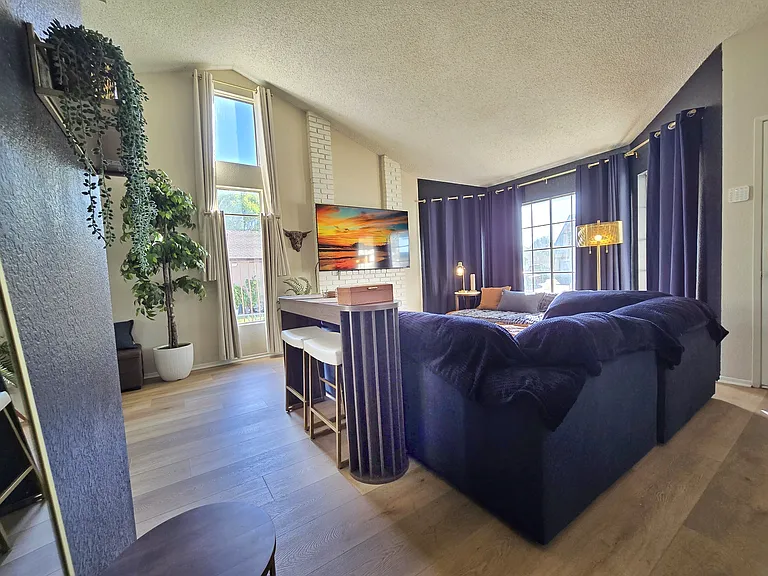 75" TV
Cozy couch
Room darkening curtains