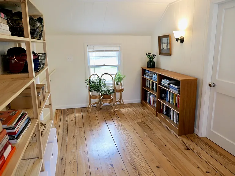 Stairway to second floor bedrooms are against back wall to the left.