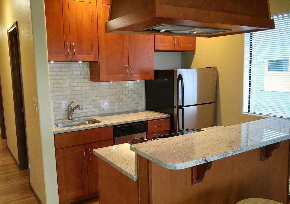 Kitchen and bar area including hallway to bathroom and bedrooms