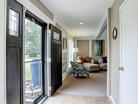 Front entrance with updated front door and storm door.