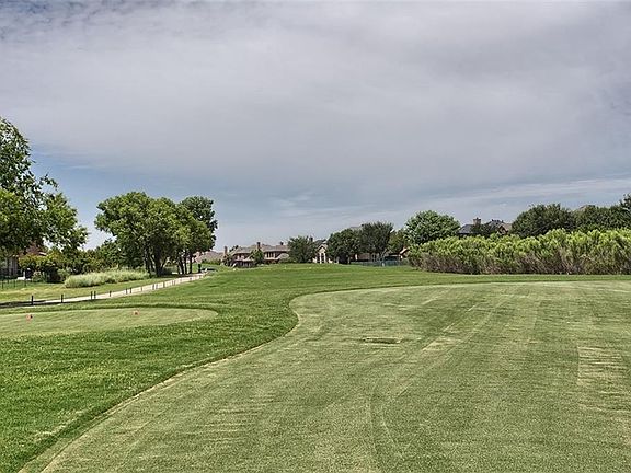 Lush trees outline the rear of the property providing privacy yet still enough space to enjoy the rolling golf course view. AMAZING!
