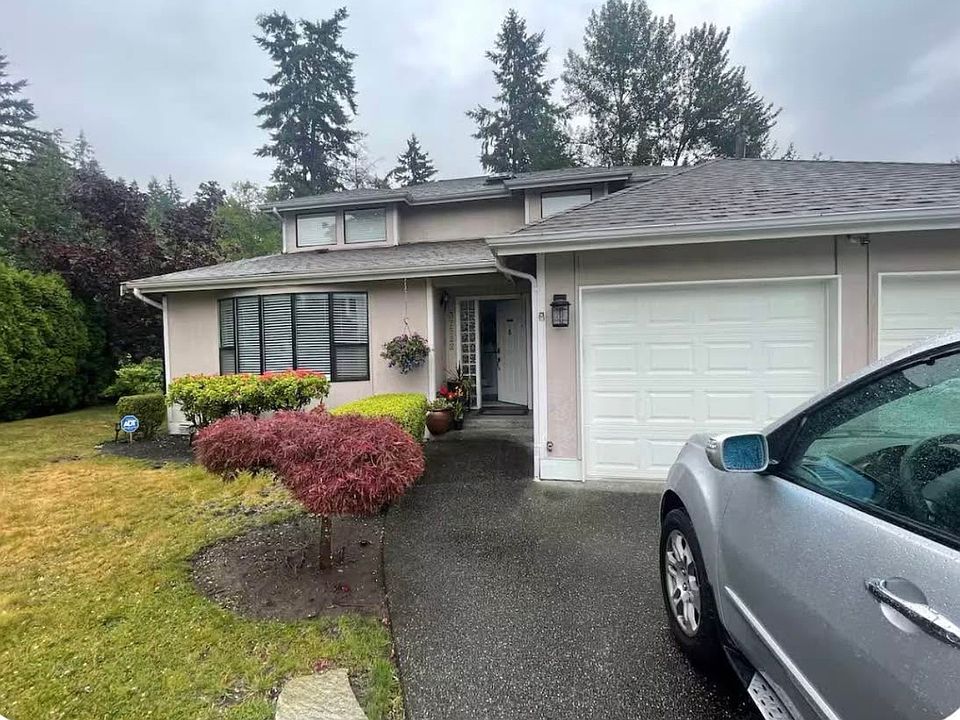 The property features a spacious driveway with parking capacity for up to four vehicles, plus an additional two-car garage, offering both convenience and ample space.