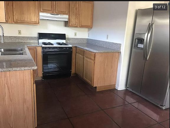 The kitchen has oak cabinets. The flooring will all be a beige porcelain ceramic tile.