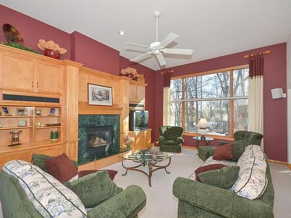 The expansive main floor family room offers a gas fireplace and gorgeous windows allowing seasonal lake views and the beauty of your private backyard.