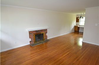 Living room with fireplace and gleaming hardwoods