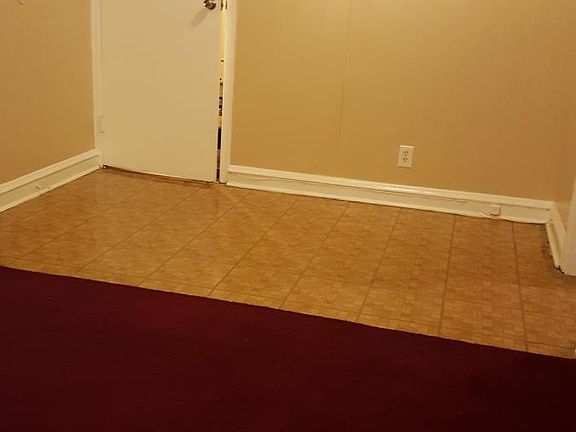 The entry way with a foyer, perfect for a book case or small