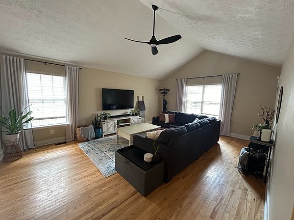 Living room features vaulted ceilings.