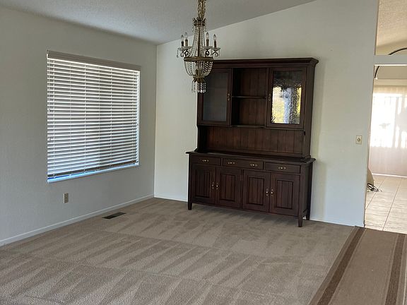 Living Room/Dining Room Combination: A generous 14.5' x 22' space with vaulted ceilings, perfect for entertaining or relaxing.