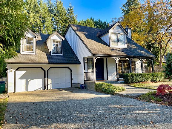 Street view of home showing garage and parking.