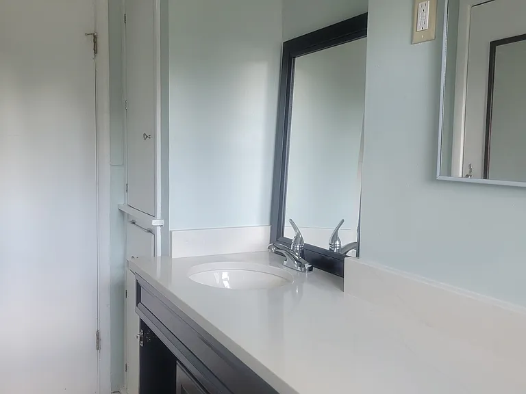 Main bathroom . New vanity, and linen closet to right of door