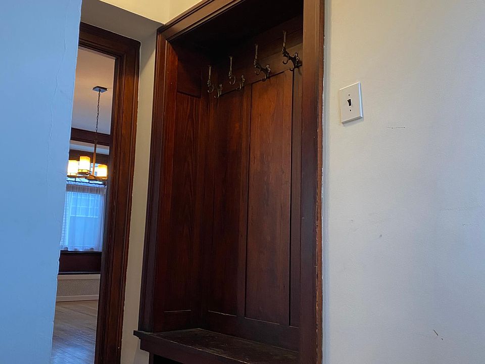 Landing at top of front entry steps with coat nook - looking beyond into dining room