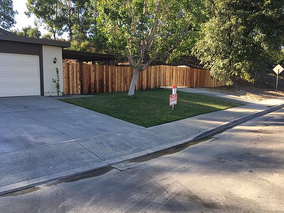 Street view of patio entry and gate access to RV pads