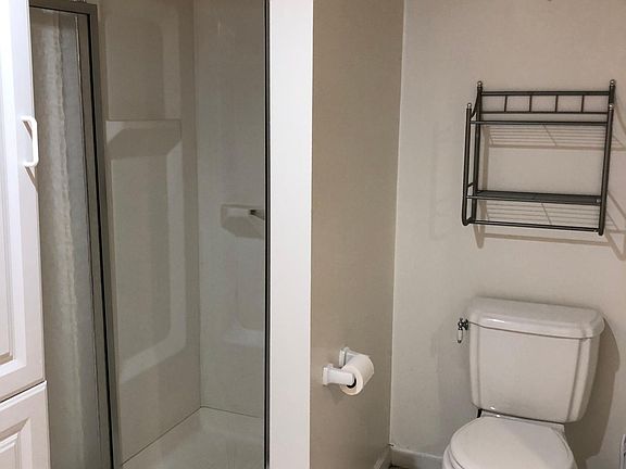 Bathroom with tile floor, stall shower