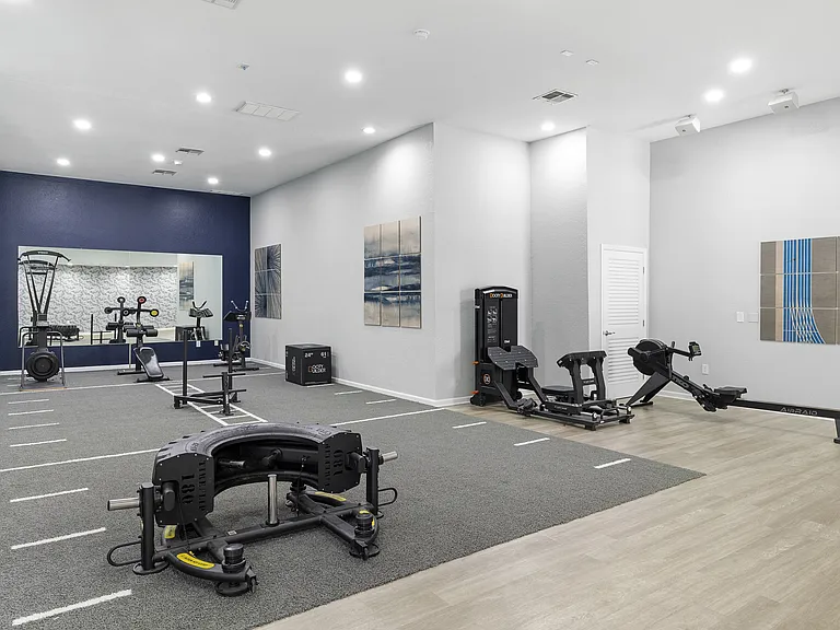 Spacious fitness center with weights, benches and machines for a complete strength routine