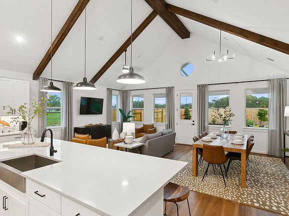 Soaring vaulted ceiling unites main living spaces