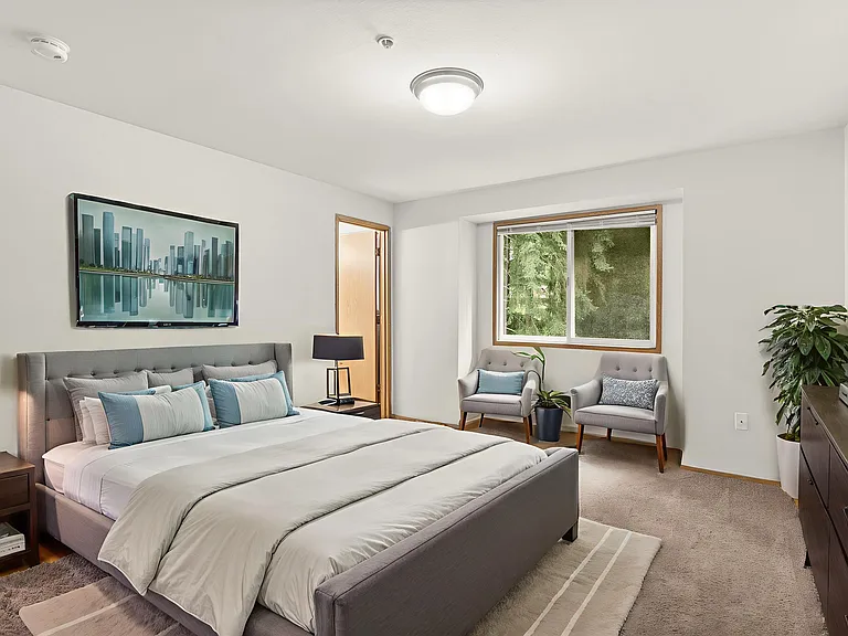 Spacious primary bedroom, virtually staged to showcase a modern bed setup, cozy seating area, and abundant natural light. Spacious primary bedroom, virtually staged to showcase a modern bed setup, cozy seating area, and abundant natural light.