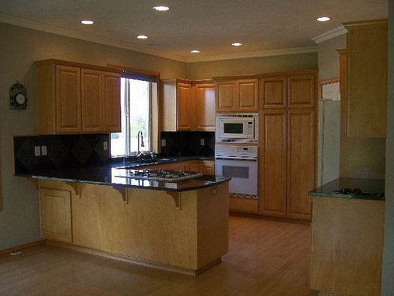 Kitchen with eating bar opening to dining area.
