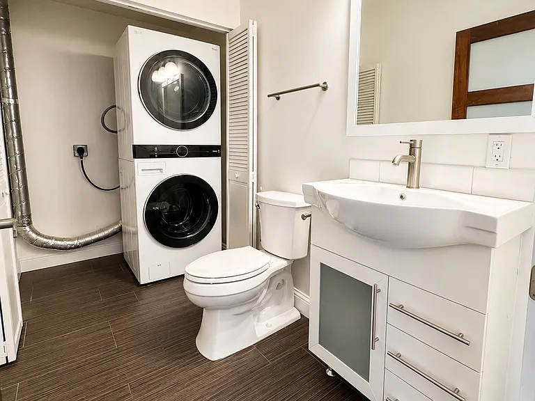 Convenient half bathroom with full-size in-unit washer and dryer.