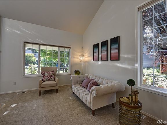 Formal living room is spacious and airy with vaulted ceiling.