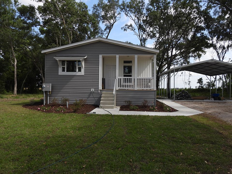 Front of the house, including porch area, sidewalk, and front yard.