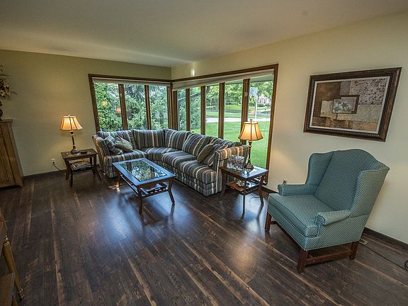 The corner windows stretch floor to ceiling and fill both the living room and formal dining area with light all day long.