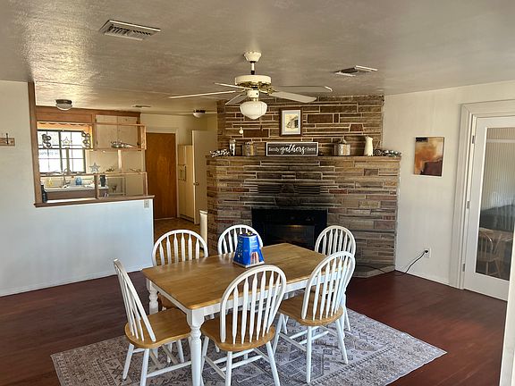 Dining room with view of kitchen and electric fireplace