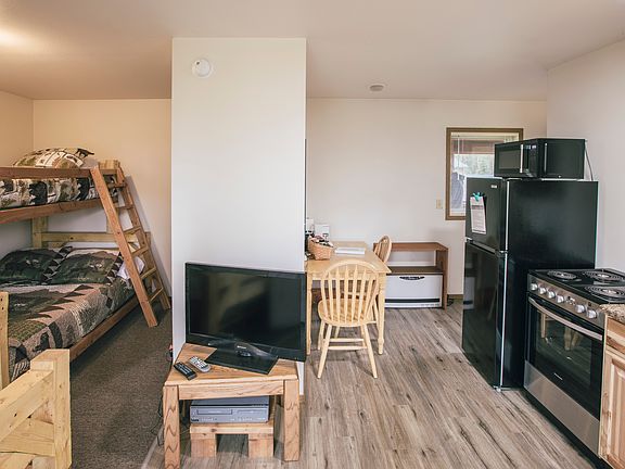 Fully furnished studio unit with kitchen, bathroom and balcony view of Kasilof River