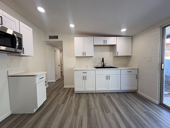 Kitchen - stainless steel appliances being installed before lease
