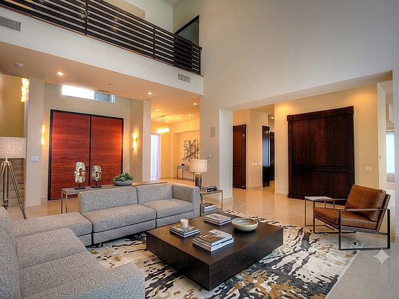 Spacious great room with soaring ceilings, abundant natural light, and seamless flow to the formal living areas.